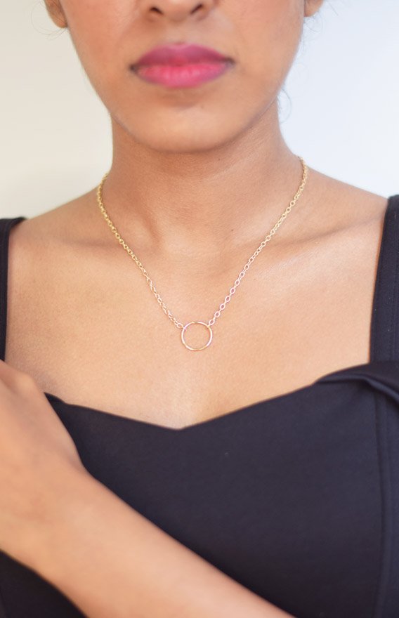 Base- Metal Alloy Adjustable length Sia Necklace features a ring pendant with dainty gold toned link chain to complement any outfit and add the extra oomph